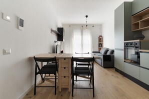 A modern kitchen with a central island, wooden flooring, and built-in appliances. - GuestHost - A comfortable and bright 55 square meters apartment, perfect for four people, located on the first floor of a building with an elevator (NOT accessible to disabled guests).The property is located in the Cascina Merlata neighborhood, a growing (Milan)