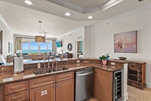 A modern kitchen with granite countertops, stainless steel appliances, and a view to the ocean. - Adagio B103 | Beach Front |Bunk room | Private Beach |Resort Style Pool YFAB (Santa Rosa Beach)