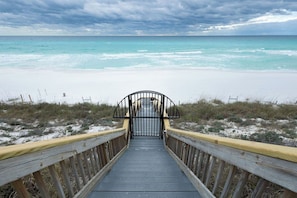 A wooden boardwalk leading to a beach with a metal gate. - Adagio B103 | Beach Front |Bunk room | Private Beach |Resort Style Pool YFAB (Santa Rosa Beach)