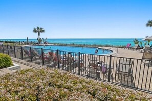 A pool area with lounge chairs and a view of the ocean. - Adagio B103 | Beach Front |Bunk room | Private Beach |Resort Style Pool YFAB (Santa Rosa Beach)