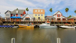 A waterfront area with colorful buildings and boats docked at the pier. - PRIVATE BEACH ACCESS, SPRING-FED LAKE, WALK TO SIESTA KEY VILLAGE! (Siesta Key)