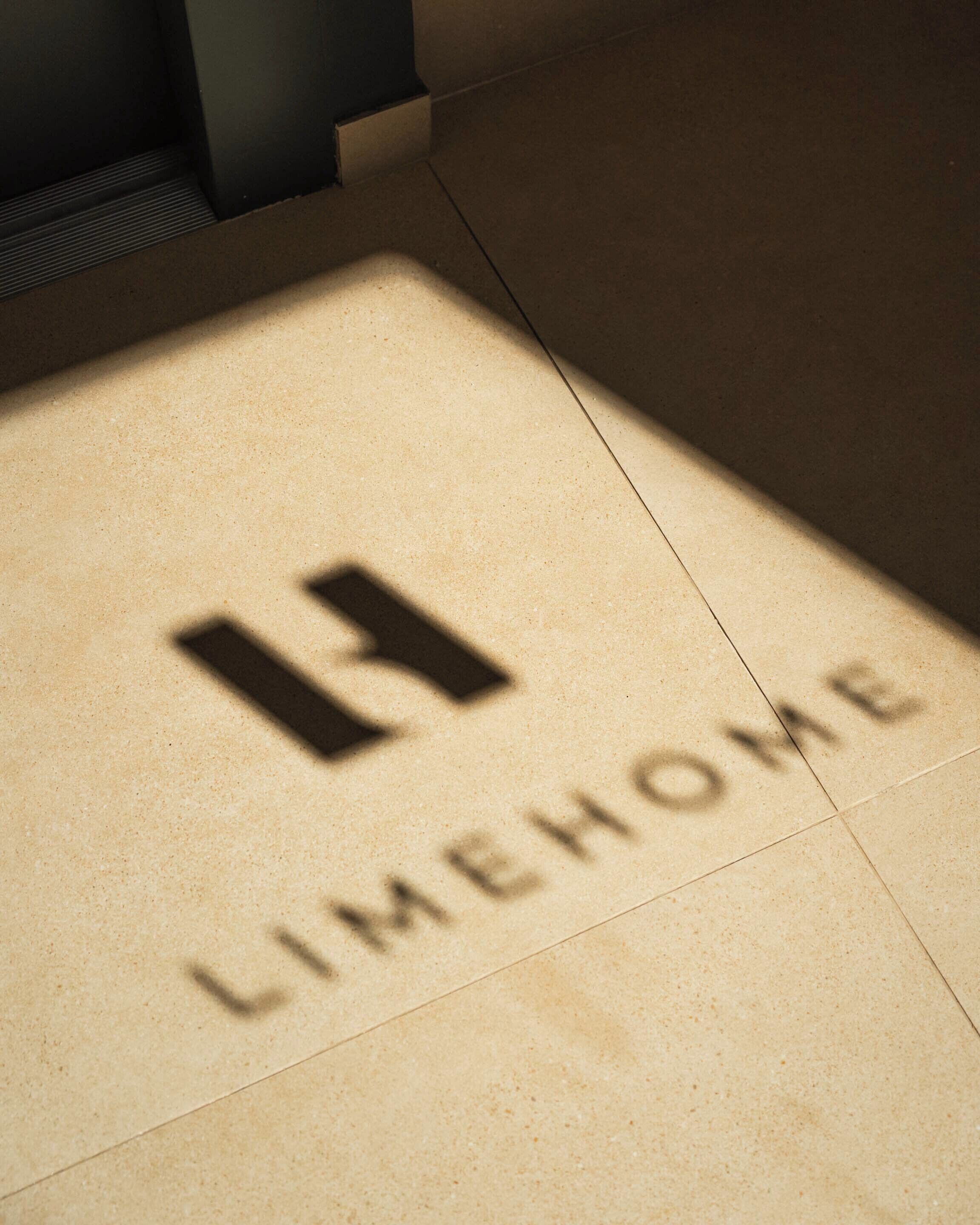A tiled floor with a logo and the word 'LIMEHOME' engraved.