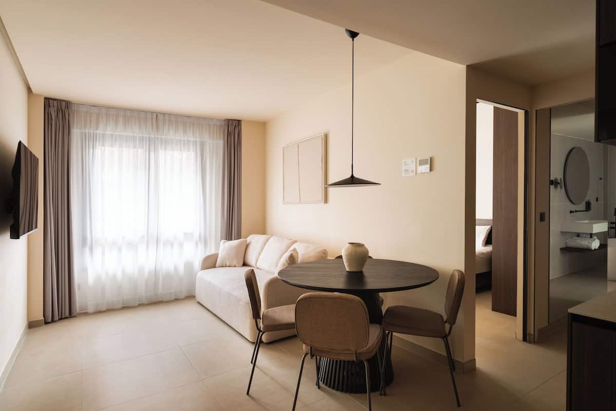 Three-Bedroom Apartment with sofa bed | Living area | 50-inch flat-screen TV with cable channels