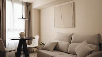 One-Bedroom Apartment with sofa bed | Living area | 50-inch flat-screen TV with cable channels