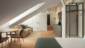 A modern loft bedroom with a dining area, kitchenette, and a staircase leading to an upper level. - Limehome Versailles Rue du Bailliage (Versailles)