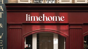 A building facade with a 'limehome' sign above a double door entrance. - Limehome Versailles Rue du Bailliage (Versailles)