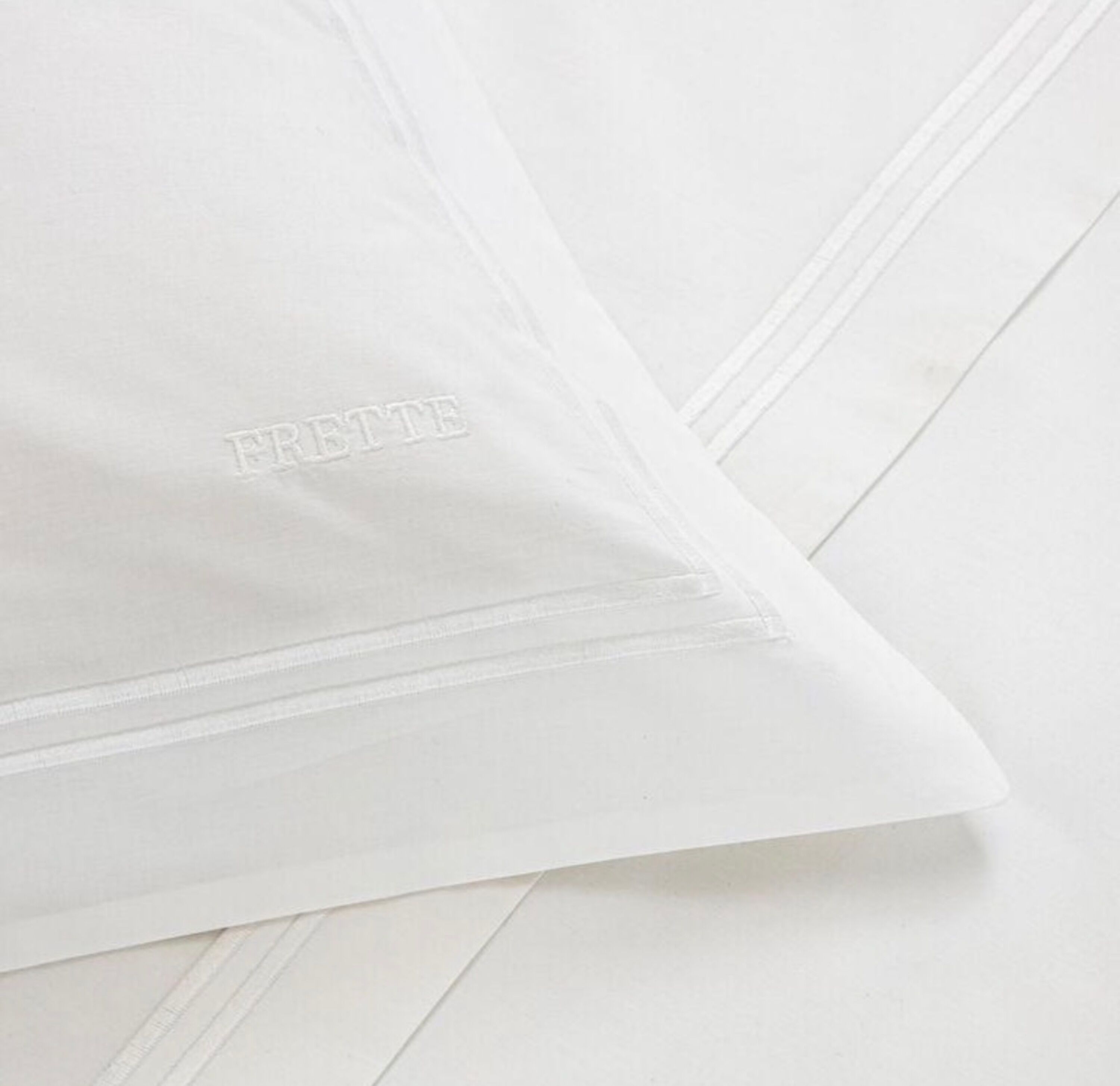 A white pillow with the word 'FRETTTE' embossed on it.