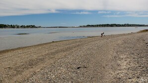 A pebbled beach with a person walking along the shore. - Eider Haven: 1  BR, 1  BA Cottage in Harpswell, Sleeps 4 (Harpswell)