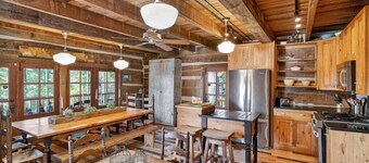 Historic lake-access log cabin on Lake Guntersville, restored from two pre-Civil War cabins. Sleeps 20 with 4BR/5BA, loft bunks, designer finishes, modern comforts, and steps to swimming, fishing & boating.