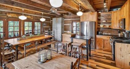 Historic lake-access log cabin on Lake Guntersville, restored from two pre-Civil War cabins. Sleeps 20 with 4BR/5BA, loft bunks, designer finishes, modern comforts, and steps to swimming, fishing & boating.