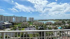 A resort with a large parking area, a central building with an archway, and a view of the ocean. - Balconies with stunning views from Master Bedroom, Living Room and 2nd Guest (Miramar Beach)