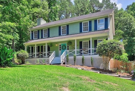 A two-story house with a porch, a front door, and a small front yard.. Welcome to Ina’s Guest Suite
Great location in Fayetteville, Georgia!