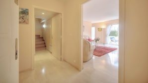 A hallway leading to a living area with a staircase, a sofa, and a red rug. - 3 Pieces EN Duplex Terrasse Centre Ville A2b103 (Cannes)