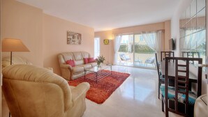 A living room with a sofa, armchair, coffee table, and dining area with chairs. - 3 Pieces EN Duplex Terrasse Centre Ville A2b103 (Cannes)