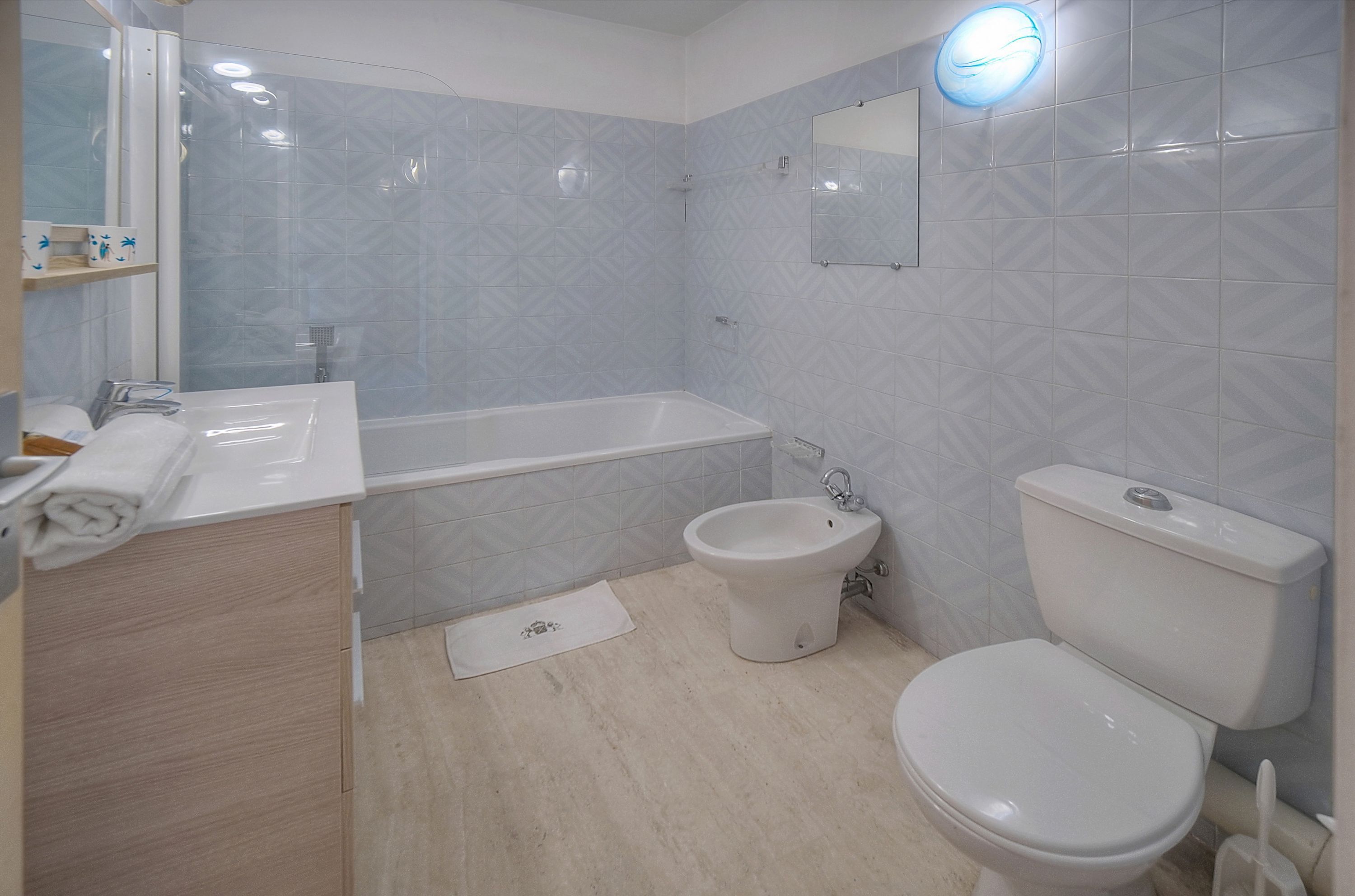 A bathroom with a bathtub, a bidet, and a toilet.
