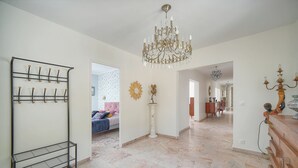 A spacious hallway with a chandelier, a coat rack, and a decorative sunburst wall piece. - 160m2-a C-vue Mer Terrasse Parking A3b132 (Cannes)