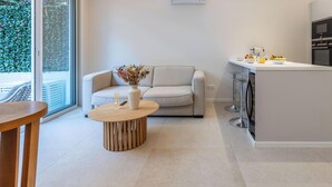 A modern kitchen with a grey island, white cabinets, and a built-in oven. - 2 Chambres-terrasse-pointe Croisette A2b267 (Cannes)