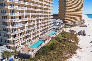 A multi-story hotel with balconies, a pool area, and a beach view. - 17th Floor Gulf-Front Luxury | 2 Baths | Beach Service Included (Panama City Beach)