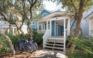 A coastal house with a porch, bicycles, and a number '130' on the post. - Son Worshipers - Seaside Home near Iconic Town Council! (Santa Rosa Beach)