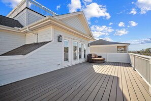 A covered outdoor deck with a wooden floor, a built-in seating area, and a view of the landscape. - 360 Views, Rooftop Deck, Across from Beach Access - 413 Tarpon Blvd (Fripp Island)