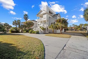 A two-story house with a covered front porch and a staircase leading to the second floor. - 360 Views, Rooftop Deck, Across from Beach Access - 413 Tarpon Blvd (Fripp Island)