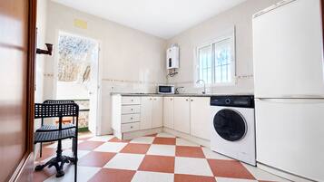 Fridge, microwave, coffee/tea maker, cookware/dishes/utensils