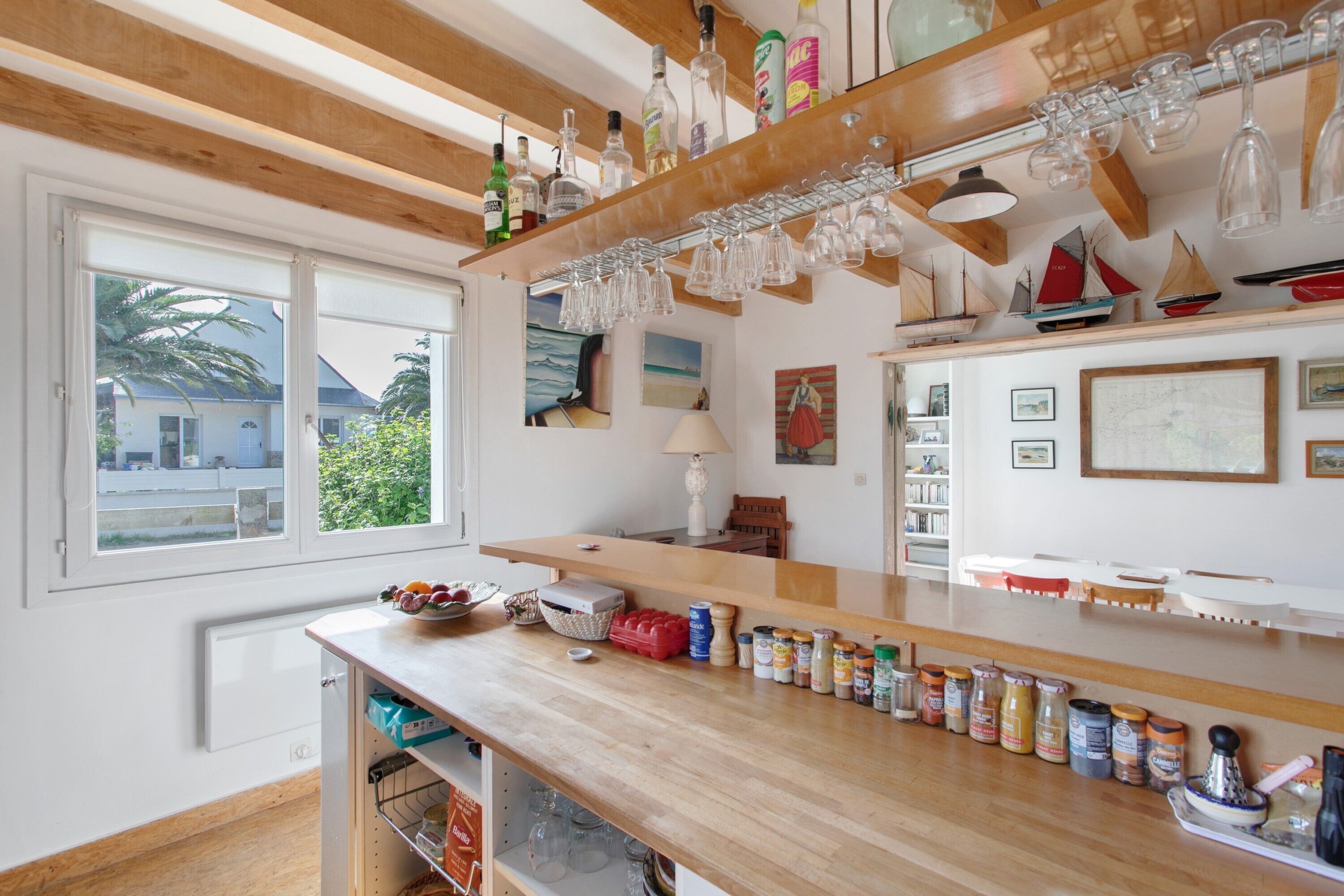 A kitchen with wooden countertops, a window with a view, and various kitchen items.
