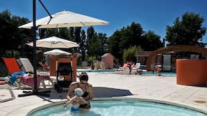 A swimming pool area with lounge chairs and umbrellas. - Chalet for 2 with Terrace in Montlaur (Montlaur)