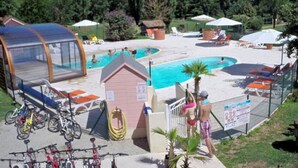 A pool area with a small pool, lounge chairs, and a covered seating area. - Cozy Chalet for 4, Garden Terrace (Montlaur)