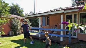 A residential area with a house featuring a covered porch and a small garden. - Cozy Chalet for 4, Garden Terrace (Montlaur)