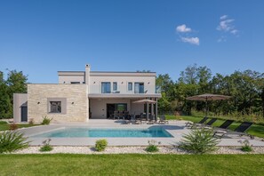 A modern two-story house with a swimming pool, outdoor seating, and a well-maintained garden. - Villa Kalea with pool (Marceljani)