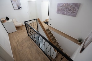 A staircase with wooden steps and a black metal railing. - Holiday Home Lantina with pool (Pridraga)