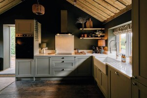 Una cucina moderna con forno integrato, lavello e finestra vista all'esterno.