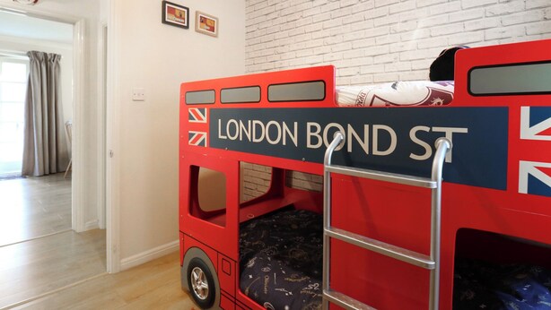 A room with a bunk bed labeled "LONDON BOND ST." and a brick wall. - Wizard's Hideaway (Watford)
