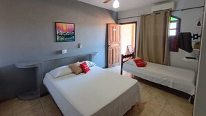 A hotel room with two beds, a ceiling fan, a painting, a desk, and a window with curtains. - Hotel Vale do Rio (Sao Goncalo do Abaete)