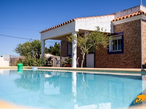 Ein Poolbereich mit einem Haus im Hintergrund.