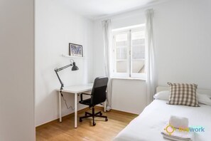 A bedroom with a bed, a desk with a chair, a window with curtains, and a small picture on the wall. - The C diz Hideaway by Livework (Cádiz)