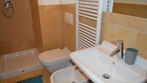 A bathroom with a shower, toilet, bidet, and sink. - The Master's Suite [In the heart of the Borgo] (Bienno)
