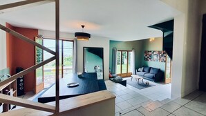 A spacious living area with a staircase, a sofa, and a coffee table.