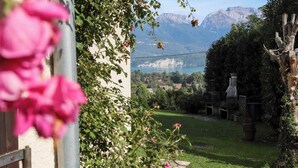 A garden with a view of mountains and a lake.
