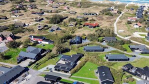 An aerial view of a coastal residential area with houses, roads, and a beach. - 4 Star Holiday Home in Blokhus (Blokhus)