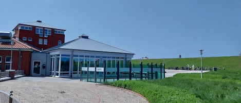 A building with a glass facade and a red brick structure.