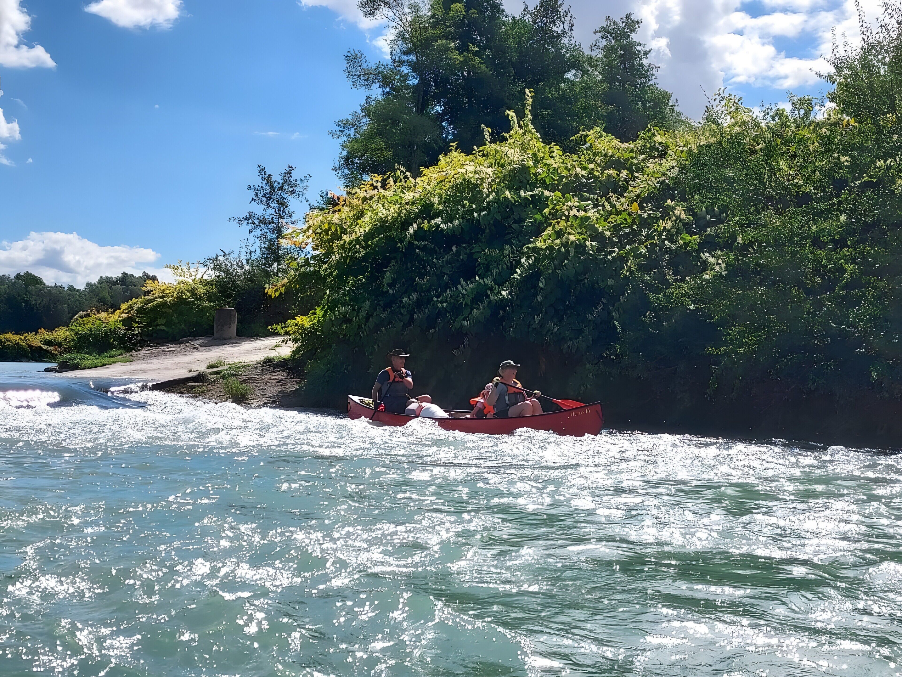 A river with a boat carrying two people.