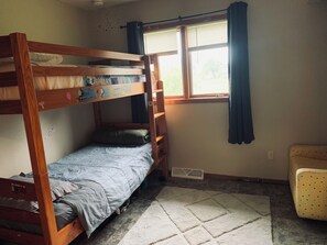 A bunk bed room with a window, a radiator, and a polka-dotted chair. - Easy access to scenic North Shore and WI South Shore - Kids and Pets welcome!! (Superior)