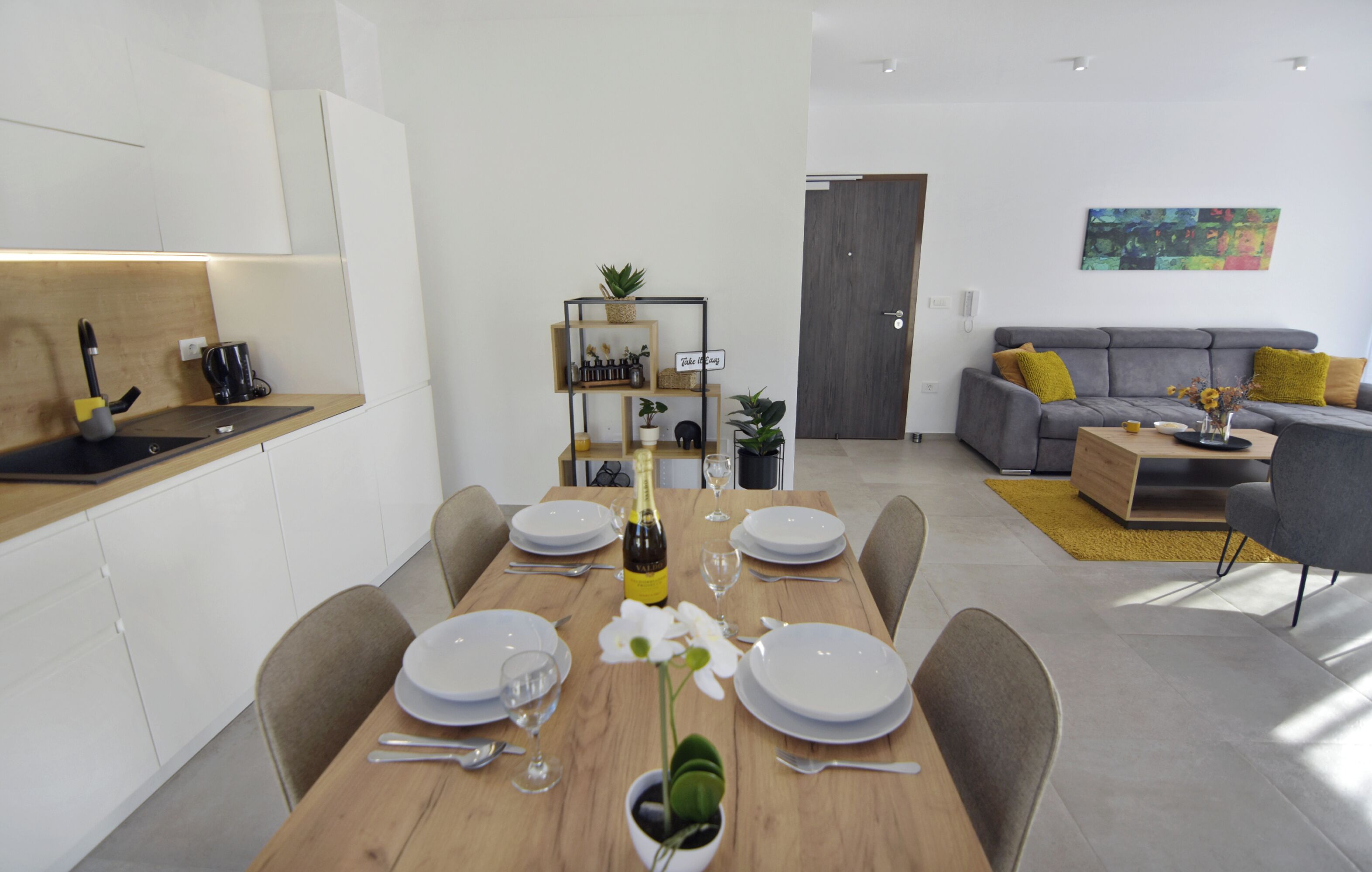 A modern living space with a dining area, a sofa, and a coffee table.