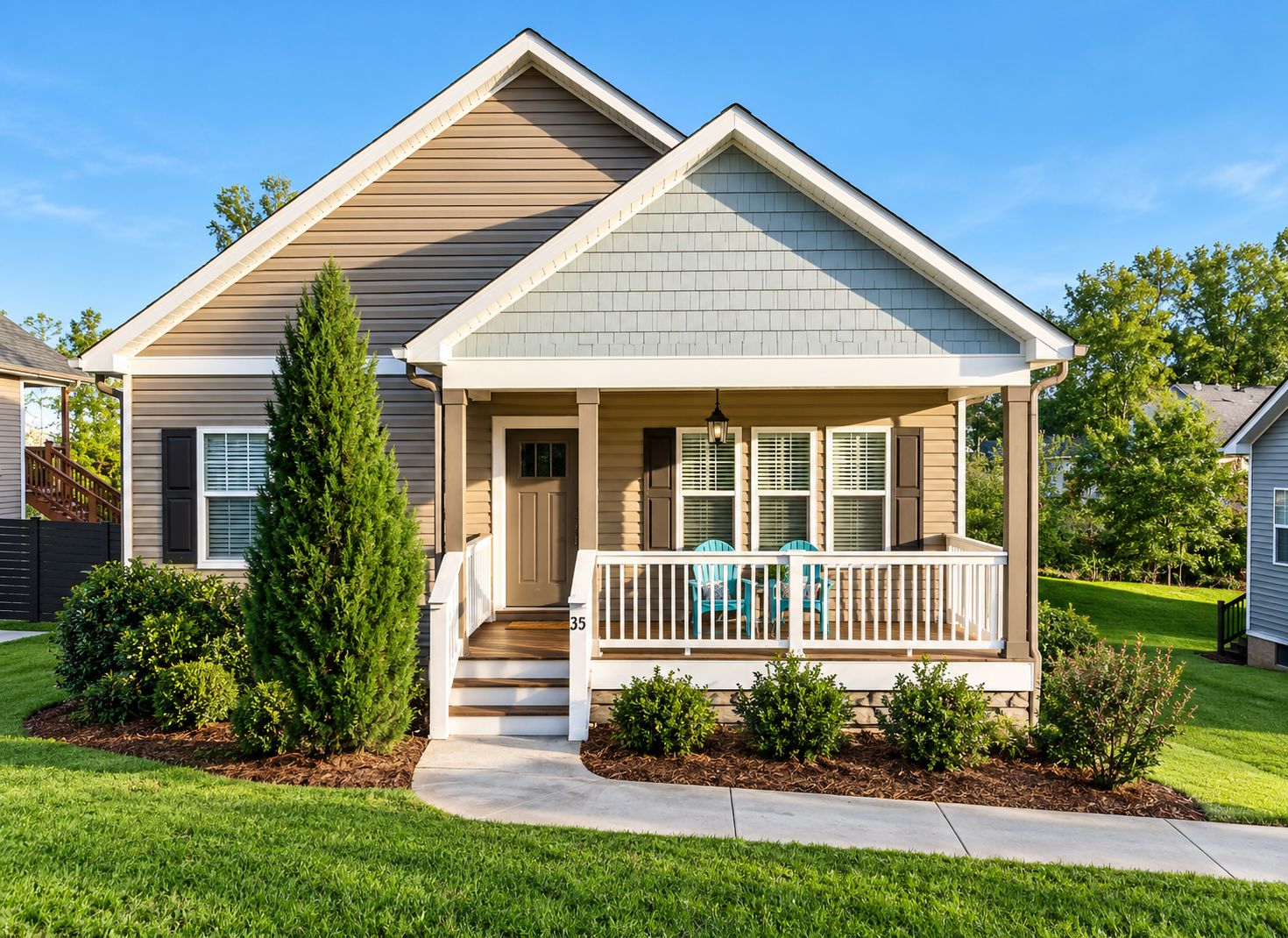 A single-story house with a front porch, a visible door, and a small set of stairs leading up to the porch.