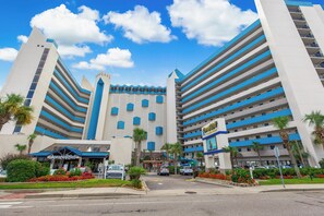 A hotel with a modern design, featuring a central tower and multiple balconies. - Wow Amazing Direct Modern Oceanfront w Fireplace/Best view at top resort (Myrtle Beach)