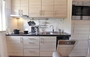 A modern kitchen with light wood cabinets, stainless steel appliances, and a dishwasher. - Cozy Flat in Central Umag (Umag)