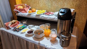 A breakfast buffet with various food items and a coffee maker. - Hostal Cerro Rico (Potosi)