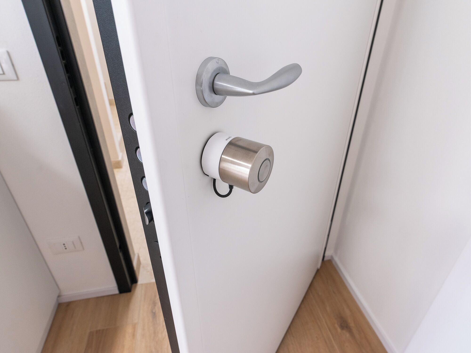 A modern door with a sleek handle and a cylindrical lock mechanism.